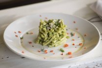 Strozzapreti pasta with celery pesto and aromatic herbs. — Stock Photo