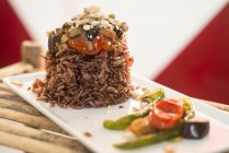 Red rice with grilled vegetables on plate, close-up. — Stock Photo