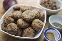Bowl of fresh lentil falafel balls with spices on table. — Stock Photo