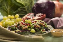 Autumnal salad with grapes, pomegranate seeds and vegetables. — Stock Photo