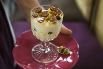 Mascarpone cream with strawberry grapes and pistachios in dessert glass. — Stock Photo