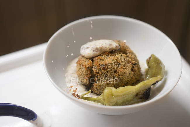 Potato and red quinoa ball with green jalapeno pepper in walnut sauce. — Stock Photo