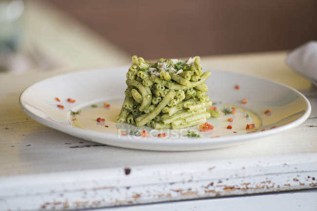 Strozzapreti pasta with celery pesto and aromatic herbs. — Stock Photo