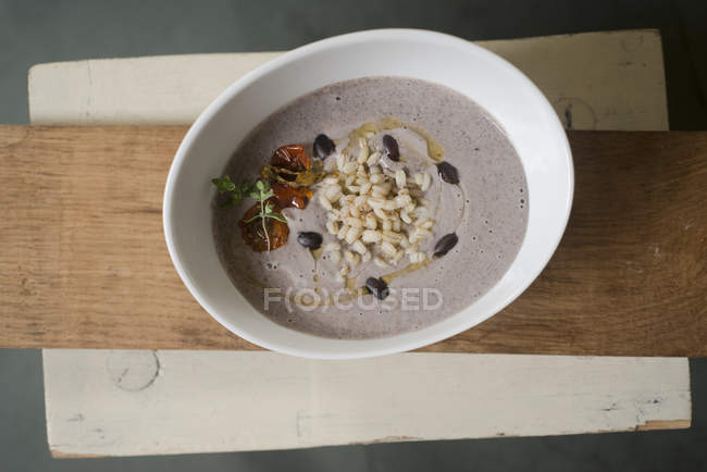Cream soup of black beans with rice and dried tomatoes. — Stock Photo