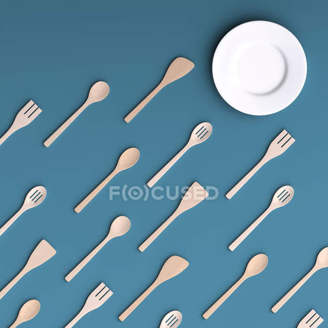 White plate with wooden kitchen tools — Stock Photo