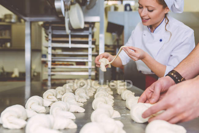 Chef preparing sweet croissant in the pastry shop laboratory — Stock Photo