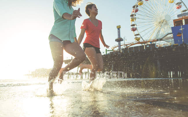 Les filles courant dans l'eau — Photo de stock