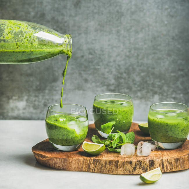 Fresh smoothie pouring from bottle — Stock Photo