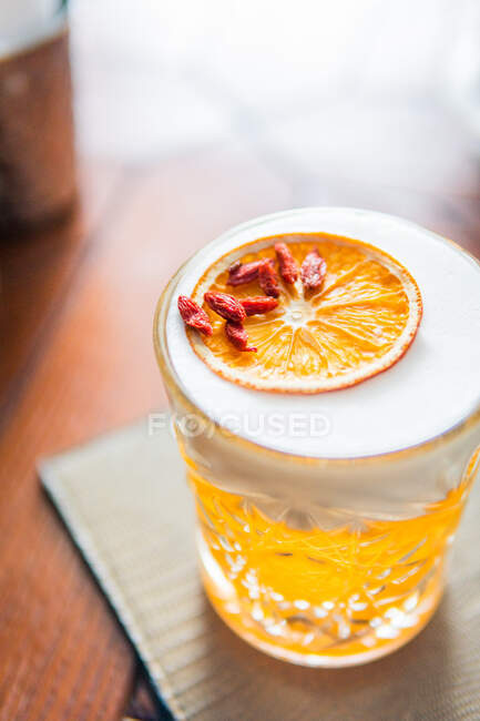 Cocktail de laranja gelada em vidro em uma mesa de madeira, close-up — Fotografia de Stock