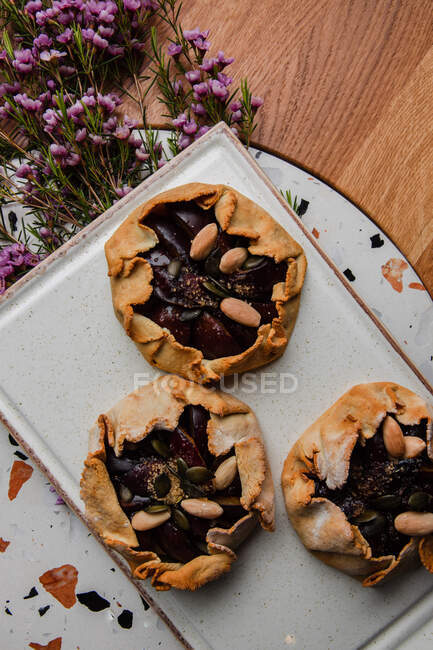Top view of  delicious homemade plum homemade pie with nuts — Stock Photo