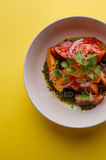 Top view of juicy salad with tomatoes, basil, and onion — Stock Photo