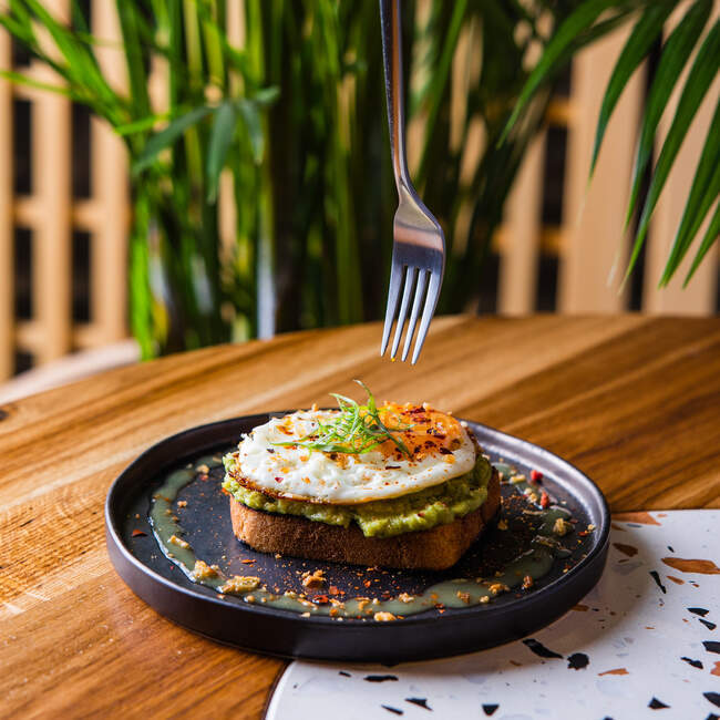 Closeup view of toast with guacamole and egg — Stock Photo