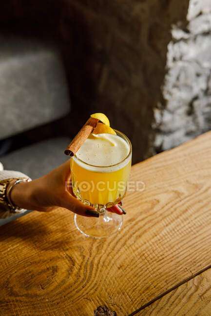 A fresh citrus cocktail with a zest and cinnamon stick — Stock Photo