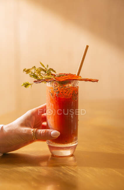 The glass of tomato cocktail dried fruit on the table — Stock Photo