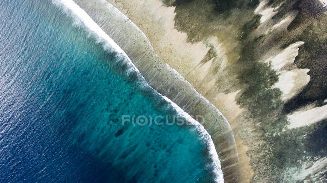 Top view aerial photo from flying drone of a wonderful nature landscape with sandy beach with beautiful coral bottom for snorkeling. — Stock Photo