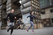 Chinese athletes running at street — Stock Photo