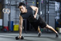 Chinese man training with dumbbells — Stock Photo
