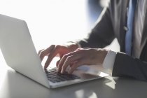 Close-up of male hands typing on laptop — Stock Photo