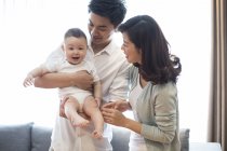Portrait of Chinese parents with baby boy — Stock Photo