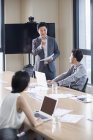 Asiáticos de negocios hablando en la sala de reuniones - foto de stock