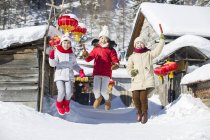 Chinese children jumping with candied haws at village festival — Stock Photo