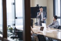 Asian business people talking in meeting room — Stock Photo