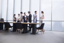 Chinese business team having meeting with foreign partners in board room — Stock Photo