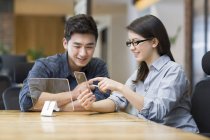 Chinese IT workers developing smartphone in office — Stock Photo