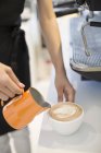 Close-up of barista hands making cappuccino — Stock Photo