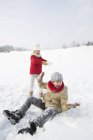 Chinese children having snowball fight in snowy park — Stock Photo