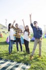 Chinese friends gesturing with beer at music festival camping — Stock Photo