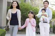 Família asiática andando na rua com bebê — Fotografia de Stock