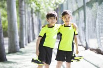 Китайские дети в спортивной одежде стоят в парке — стоковое фото