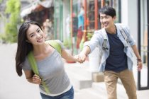 Chinese couple holding hands on street in Beijing — Stock Photo