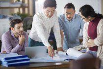 Architects discussing blueprints in office — Stock Photo