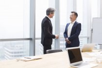 Businessmen talking in meeting room — Stock Photo