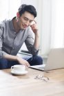 Asian man working with laptop in office — Stock Photo