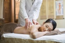 Chinese woman receiving shiatsu massage — Stock Photo