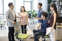 Team of Chinese business people discussion work in meeting — Stock Photo