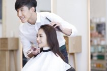 Chinese barber cutting customer hair — Stock Photo