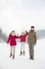 Família chinesa com filha posando na neve — Fotografia de Stock