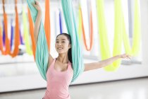 Asian  woman practicing aerial yoga — Stock Photo