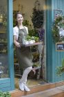 Женщина-флористка Китая держит в магазине горшки с растениями — стоковое фото