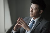 Portrait of pensive chinese businessman — Stock Photo