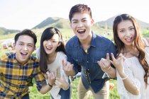 Chinese friends gesturing at music festival camping — Stock Photo