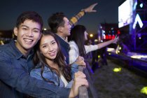 Chinese friends watching concert at music festival — Stock Photo