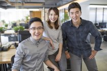 Chinese IT workers standing in office — Stock Photo