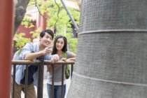 Chinese couple observing bell at Lama Temple — Stock Photo