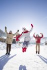 Chinese children jumping in snow — Stock Photo