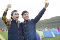Chinese male friends drinking beer and cheering together — Stock Photo
